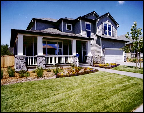 blue gray house with green lawn